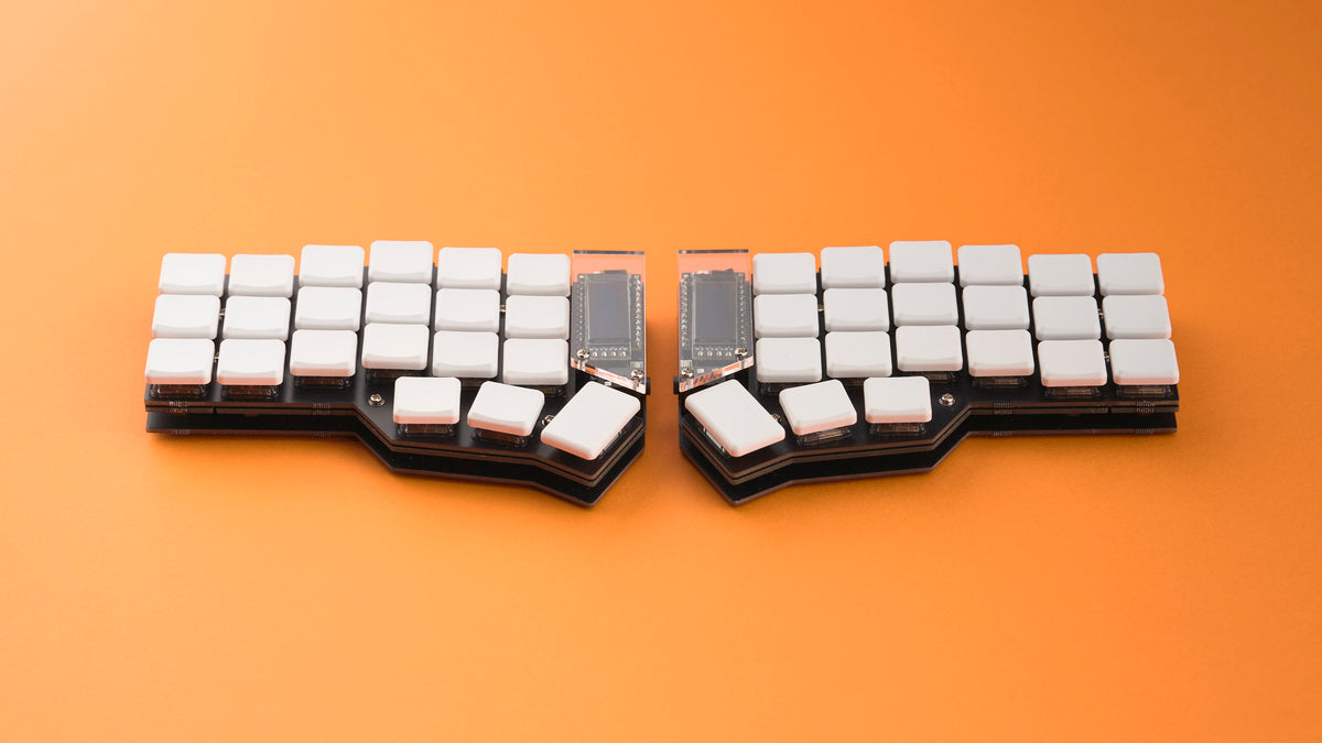 Fully built Corne keyboard from DIY Kit with FR4 case and white keycaps, photographed on bright orange backdrop