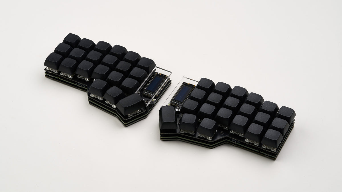 Assembled Corne DIY split keyboard with matte black keycaps and OLED screens, shown against a soft white background.