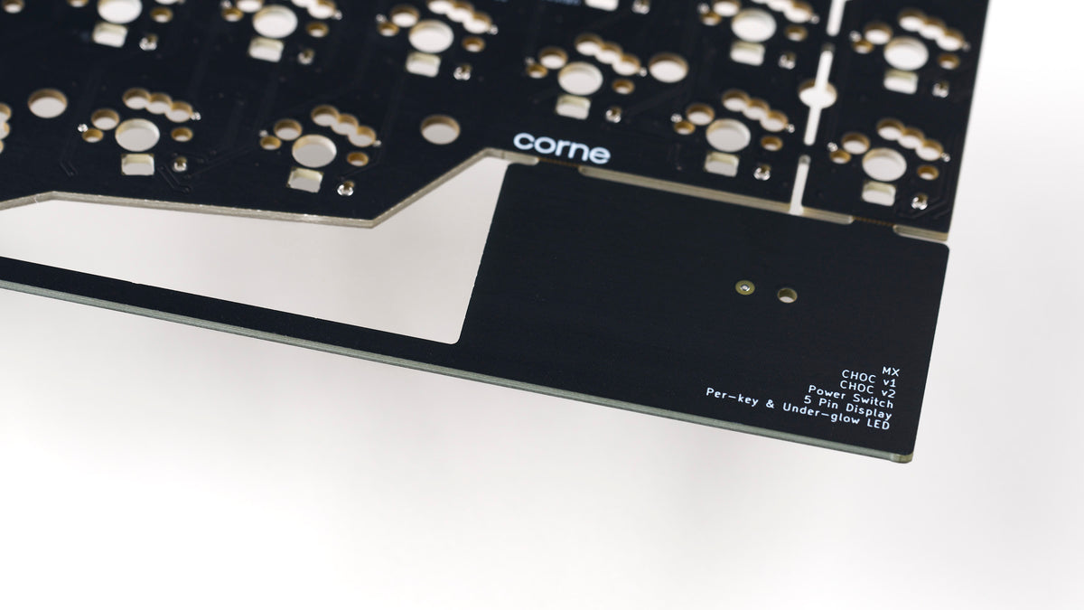 Detail view of Corne v3.6 PCB breakaway tab with printed feature list and corne logo