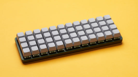 Equals 48 ortholinear keyboard on yellow background with grey keycaps