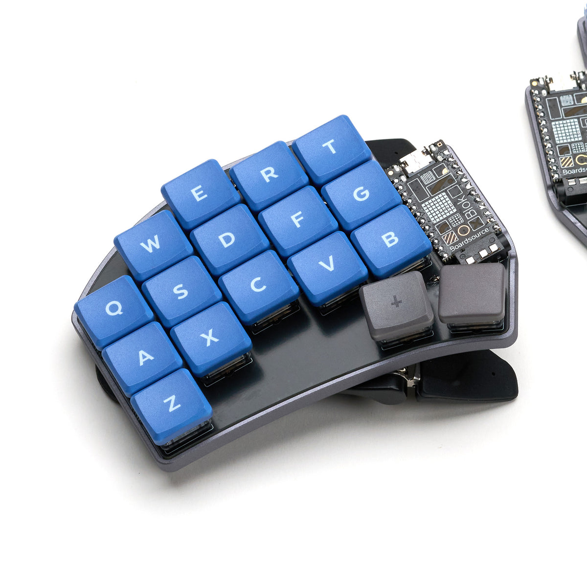 Side view of blue keycaps on the Crab Broom keyboard showing curvature and tripod tenting system