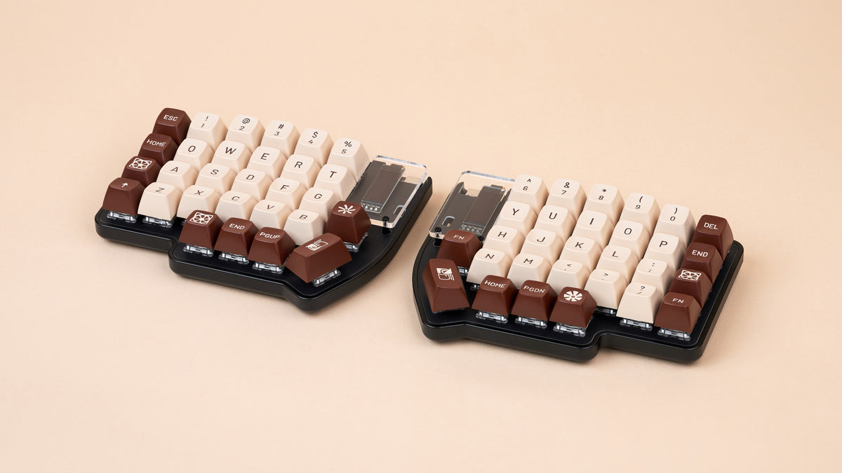 Lily Pad aluminum case build with brown and beige keycaps, shown split on soft peach background.
