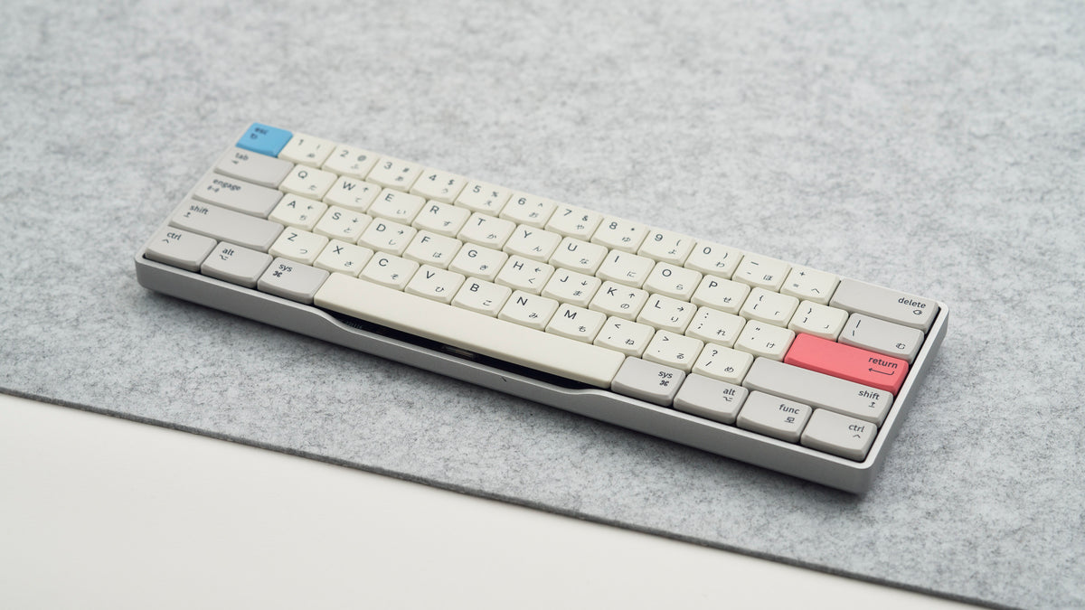 Rechteck wireless mechanical keyboard in silver aluminum finish on a felt deskmat with MBK Engage Light keycaps